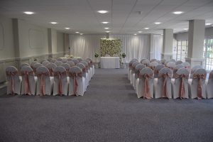 White Spandex Chair Covers with Rose Gold Satin Sashes