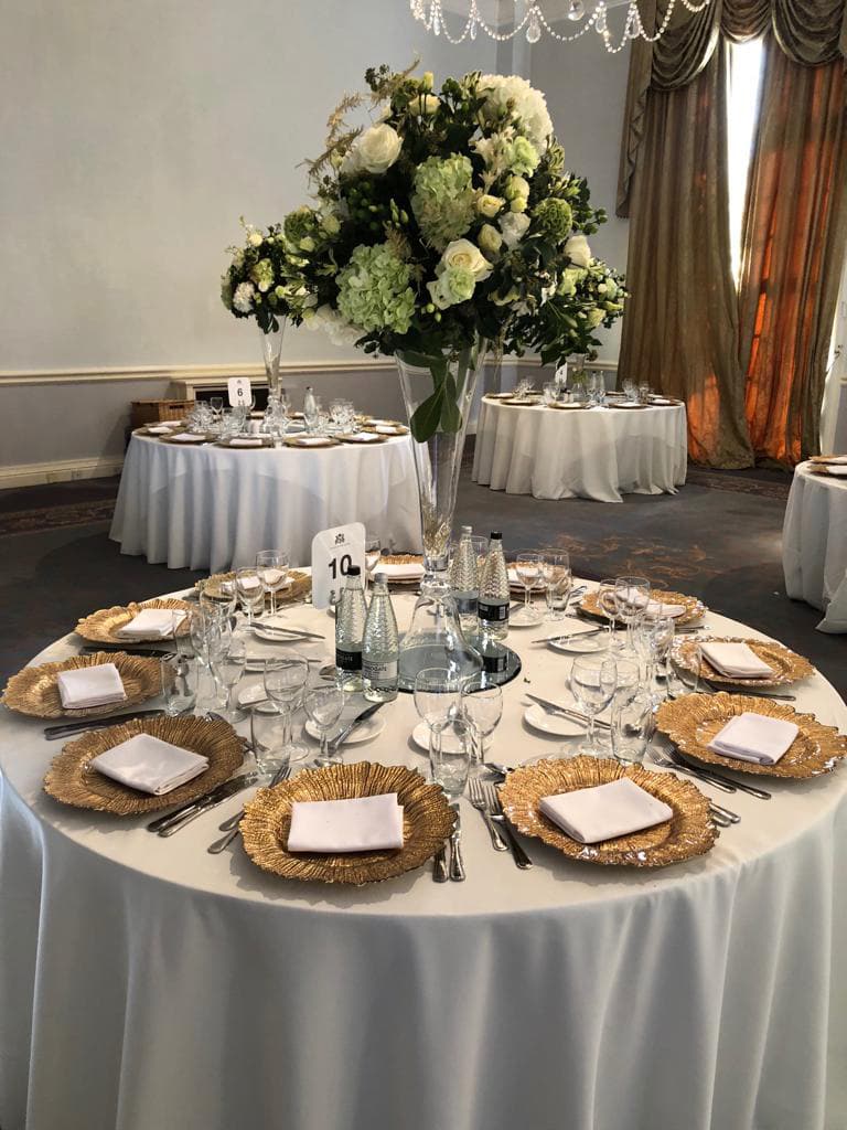 6ft Round Ivory Tablecloths and Gold Glass Floral Leaf Charger Plates