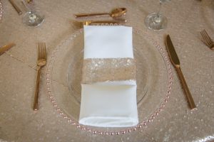 Rose Gold Charger Plate, White Napkin, Sequin Napkin Holder and Rose Gold Cutlery