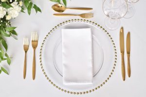 Gold Beaded Charger Plate, Gold Cutlery, White Napkin and Gold Rimmed Glassware