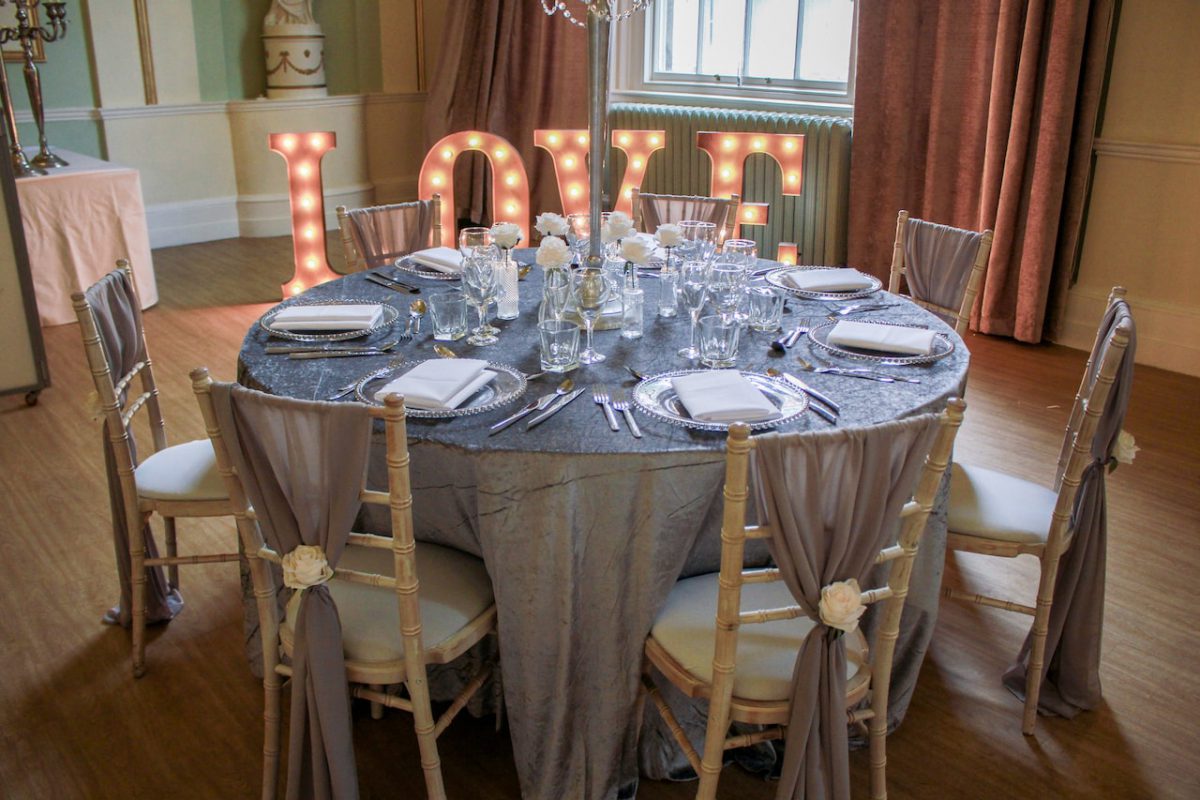 Crushed Velvet Table Cloth, Grey Chiffon Drops, Silver Beaded Charger Plates and LOVE Letters